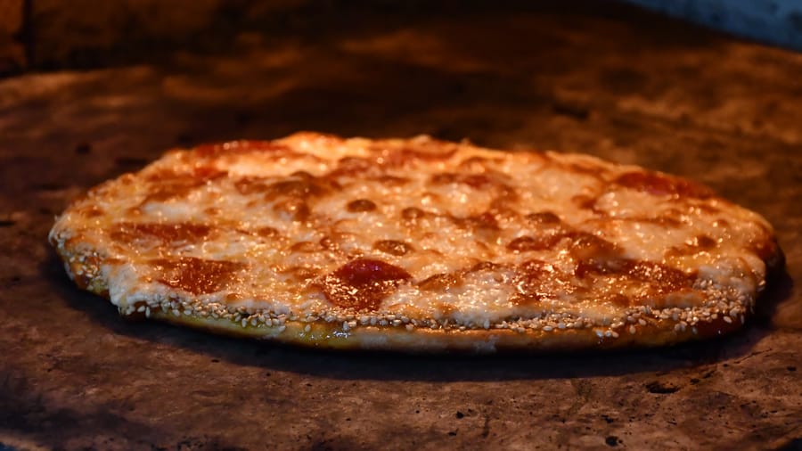 Pizza recién horneada saliendo del horno